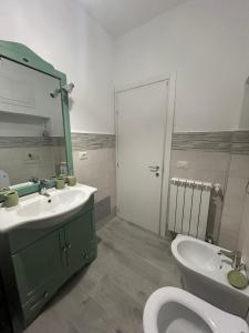 a bathroom with a sink and a toilet and a mirror at La Piazzetta in Tivoli