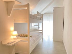 a bedroom with two bunk beds and a lamp at Il Castelluccio in San Vincenzo