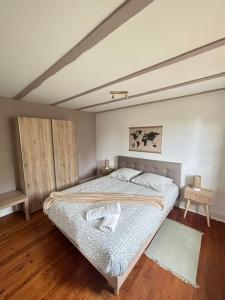 a bedroom with a bed and a wooden floor at Le Cocon du Vignoble - Free Wifi - Netflix in Turckheim