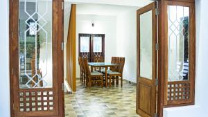 a dining room with a table and chairs at The Cascade Munnar in Anachal