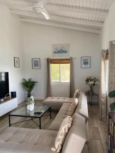 a living room with a couch and a table at Stunning Villa overlooking Friendship Bay Beach in Union