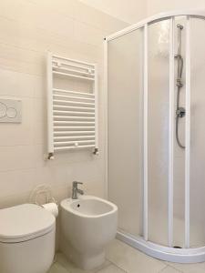 a bathroom with a shower and a toilet and a sink at Il Castelluccio in San Vincenzo