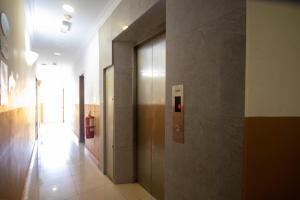 a hallway of a building with a fire extinguisher at SUN INNS PERMAS JAYA in Johor Bahru
