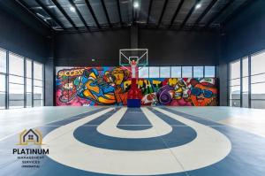 a basketball court in a gym with a wall of graffiti at Executive Escapes [The Netizen Cheras] 3房公寓 #MRT in Cheras