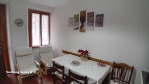 a dining room with a white table and chairs at Il Pianello in Poppi