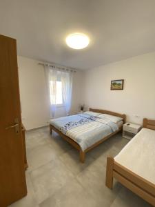 Postel nebo postele na pokoji v ubytování Apartmani Radosav