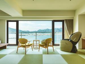 a living room with a view of the ocean at Etajimasou in Etajima