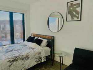 a bedroom with a bed and a mirror and a window at Cozy apt with great city view in Union City