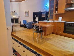 a kitchen with a table and a chair in it at City Center Apartment in Arta