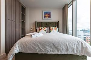 a bedroom with a large bed with a large window at The Lexington - Luxury Serviced Apartments City Centre - City and Waterfront views in Liverpool