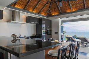 a kitchen with a large island with a counter top at Luxury villa Seaview & Sunset 100m from the beach in Ko Phangan