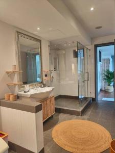 a bathroom with a sink and a glass shower at Luxury villa Seaview & Sunset 100m from the beach in Ko Phangan