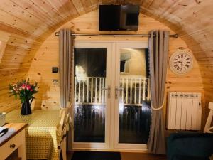 a room with a door with a tv on top at The Pod Over By in Kilmichael Glassary