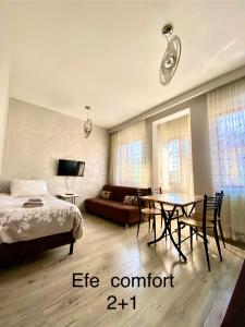 a bedroom with a bed and a table and a couch at IMC Fatih Apartments in Istanbul