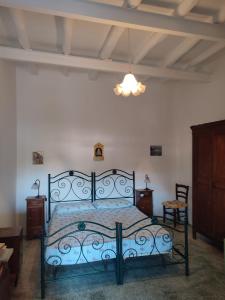 a bedroom with a bed with a blue comforter at Casa Amena con ampio terrazzo e giardino in Lipari