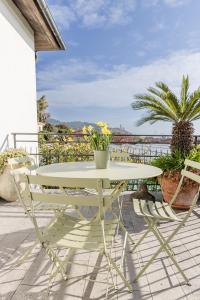 een witte tafel en 2 stoelen op een patio bij Casa delle Zagare in San Bartolomeo al Mare