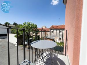 a white table on the balcony of a building at Basovizza 3 Nicole Tirabora Short Rent in Villa Opicina