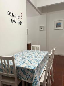 a table with a blue and white table cloth on it at Cocciu D’amuri in Palermo