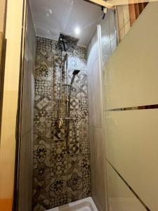 a shower with a glass door in a bathroom at Cocciu D’amuri in Palermo