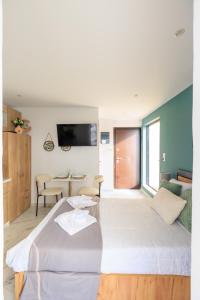 uma grande cama branca num quarto com uma mesa em Aiolos luxury loft new Smyrni centre em Atenas