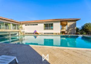 a swimming pool in front of a house at MyStay - Lagos House in Braga