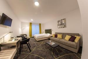 Hotel Valcha في براغ: غرفة معيشة مع أريكة وطاولة