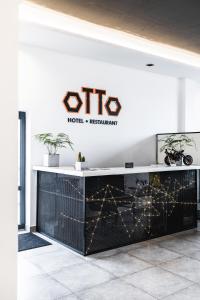 a lobby of a hotel with a sign on the wall at Otto Hotel-Restaurant in Veresneve