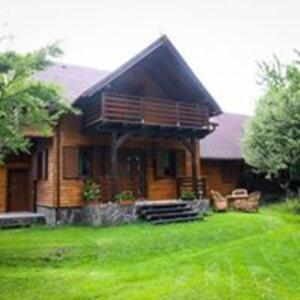 a house with a large yard in front of it at Katinka Kulcsosház - Cabana Katinka in Bucsin