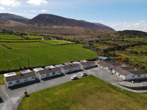 an aerial view of a building with a field and mountains at Mountain View Cottages in Tralee