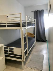 two bunk beds in a room with a window at My Hostel in Guimarães