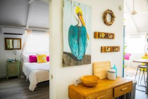 a room with a bird painting on the wall at The Royal Wait - An Elegant Retreat in Christiansted