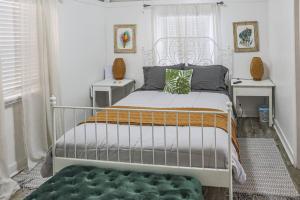 a bedroom with a white bed and two night stands at Blackbeards Rendezvous Downtown Danish Villa in Christiansted