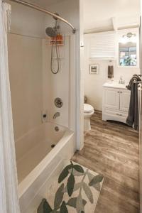 a bathroom with a tub and a toilet and a sink at Blackbeards Rendezvous Downtown Danish Villa in Christiansted