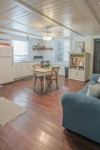 a living room with a table and a kitchen at The Roosters Perch - A Quaint Island Homestead in Christiansted