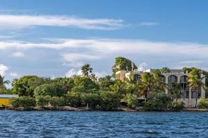 a house on the shore of a body of water at The Roosters Perch - A Quaint Island Homestead in Christiansted