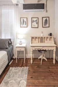 a bedroom with a desk and a bed and a table at The Danish Nydam - A Sailors Mooring in Christiansted