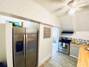 a kitchen with a stainless steel refrigerator and a stove at The Mary Read - A Pirates Serenity in Christiansted