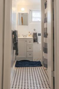 a bathroom with a black and white tiled floor at The Mary Read - A Pirates Serenity in Christiansted +38 photos