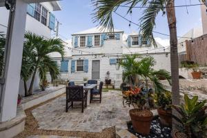 a patio with a table and chairs in front of a house at The Mary Read - A Pirates Serenity in Christiansted