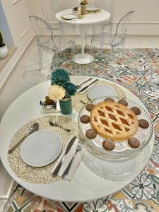 a table with a plate with a waffle and cookies at Il Casale Normanno in San Vito dei Normanni