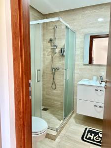 a bathroom with a shower and a toilet at Luxury apartments in Marrakesh