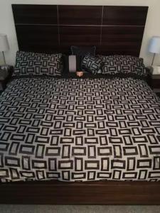 a bed with a black and white comforter at Lake Las Vegas Resort Vacation in Las Vegas