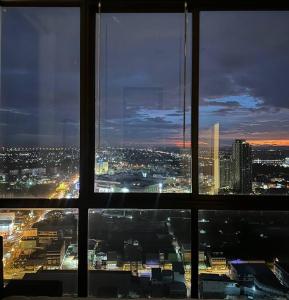a view from a window of a city at night at HMJ3 Entire Apt on 33rd floor in Khonkaen city center in Khon Kaen