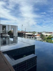 a view of a building with a pool of water at HMJ3 Entire Apt on 33rd floor in Khonkaen city center in Khon Kaen
