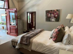 a bedroom with a bed with pillows on it at The Courtyard at La Loggia in Nottingham Road