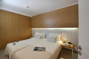 a bedroom with a large bed with a book on it at Broncemar 519 By VillaGranCanaria in San Bartolomé de Tirajana