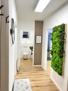 a hallway with a bathroom with a green wall at Skyview Residence - Self Check In - Near City Centre in Graz