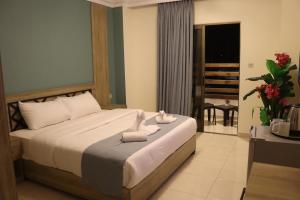 a bedroom with a bed with towels on it at Mariam Boutique Hotel in Aqaba