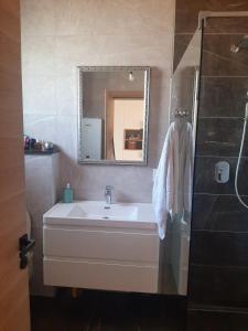 a bathroom with a sink and a mirror at Vikendica Krcmarice- Banja Luka in Banja Luka