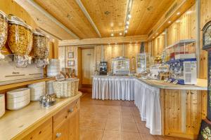 a large kitchen with wooden walls and wooden counters at Pension Salzsäumer in Neuschönau